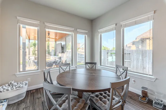 a view of a dining room with furniture and wooden floor