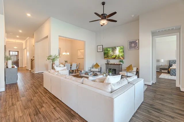 a view of a kitchen counter space with wooden floor and furniture