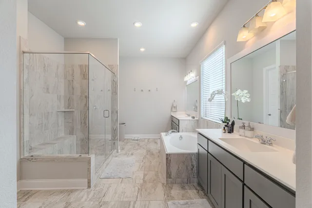 a bathroom with a double vanity sink toilet and shower