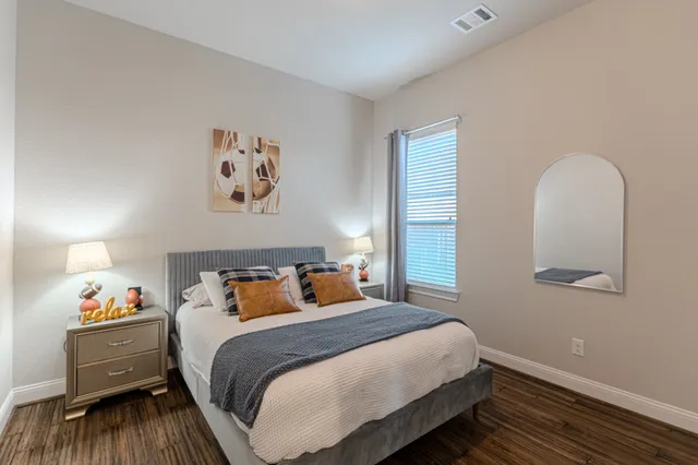 a bedroom with a bed and a window