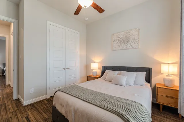 a bedroom with a bed and a painting on the wall