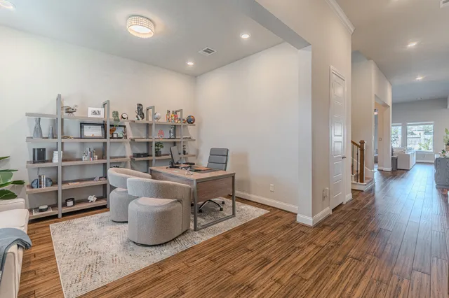 a living room with furniture a rug and a wooden floor