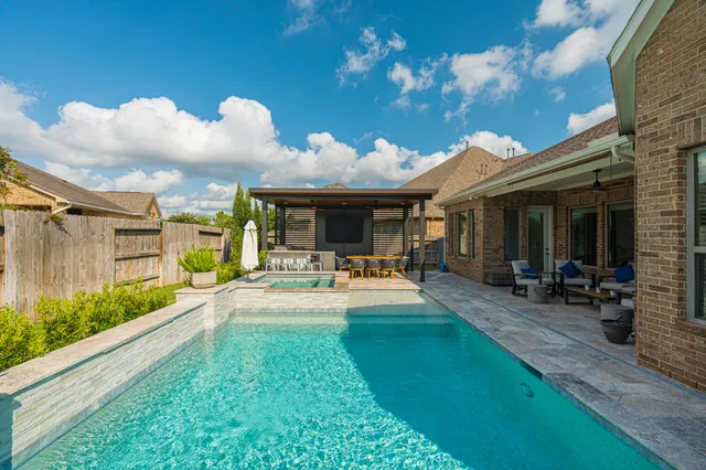 a view of a house with patio and a yard