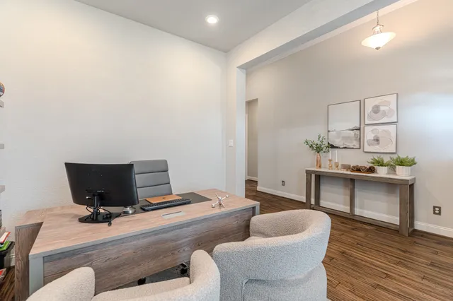 a bedroom with furniture and a wooden floor