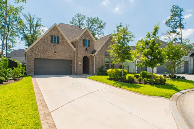 a front view of a house with yard and green space