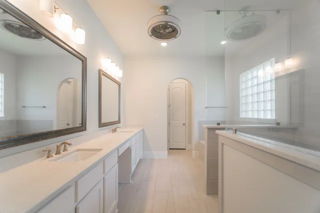 a spacious bathroom with a double vanity sink mirror and double