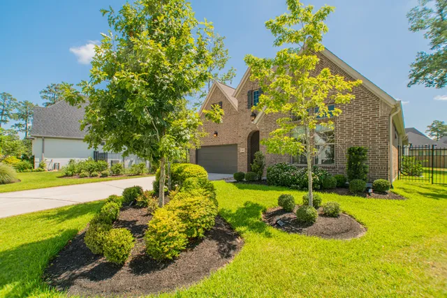 a front view of a house with garden and patio