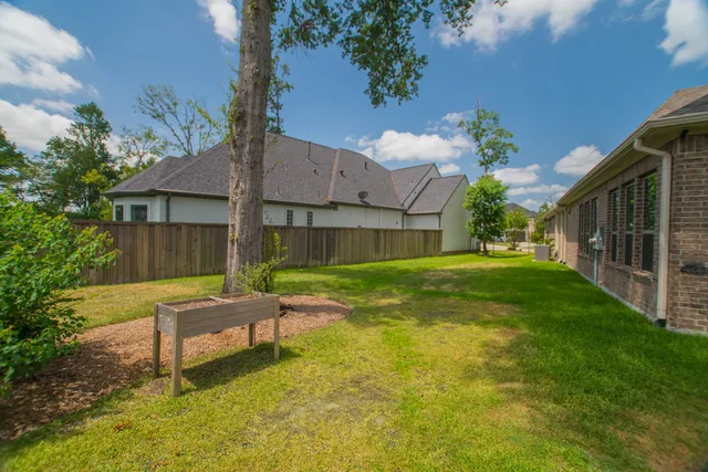 a view of a house with a yard and sitting area