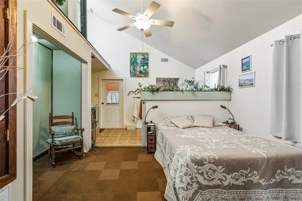 a bedroom with a large bed and a chandelier