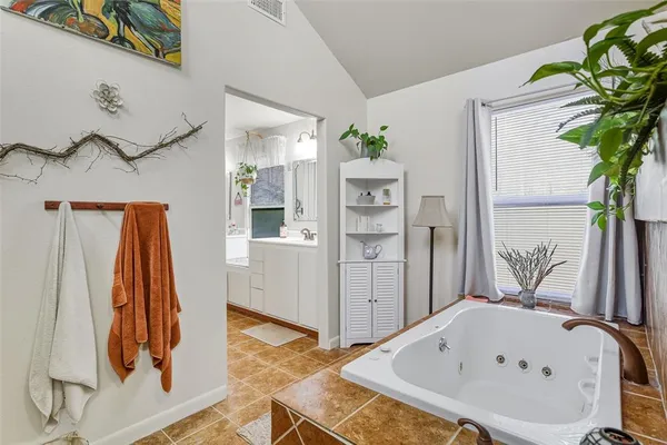 a bathroom with a bathtub and a window