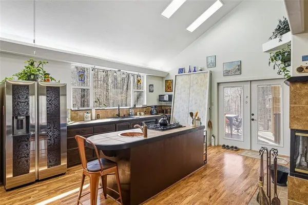 a dining room with stainless steel appliances a table and chairs
