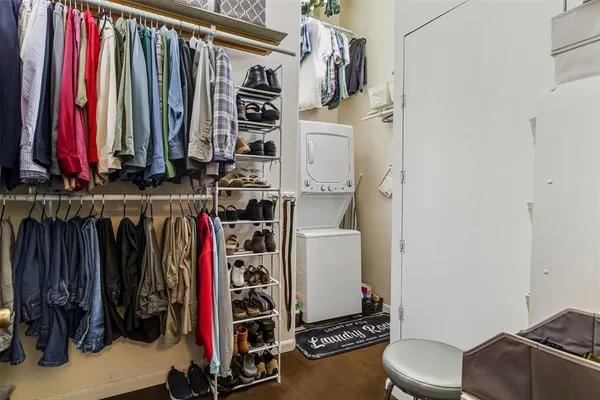 a view of walk in closet with clothes