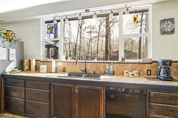 a bathroom with a sink a mirror and a window