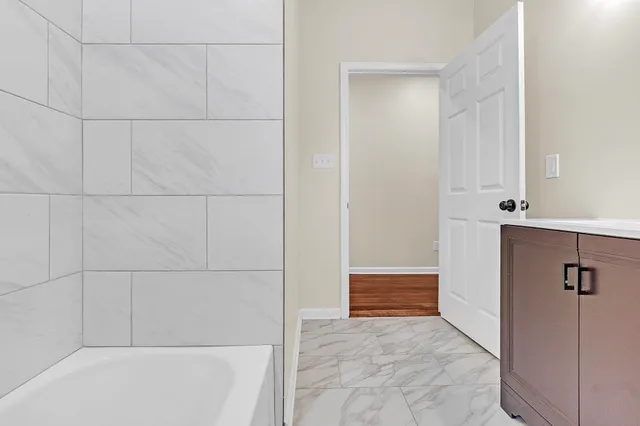 a view of kitchen with wooden floor and electronic appliances