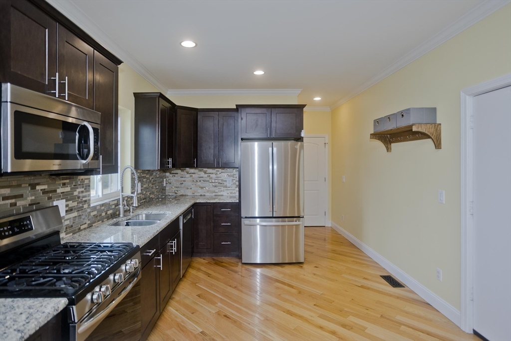 48 Mountain Avenue West Springfield, MA 01089 - Photo 15 of 39 a kitchen with granite countertop a refrigerator stove and microwave