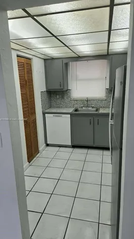 a stove top oven sitting inside of a kitchen