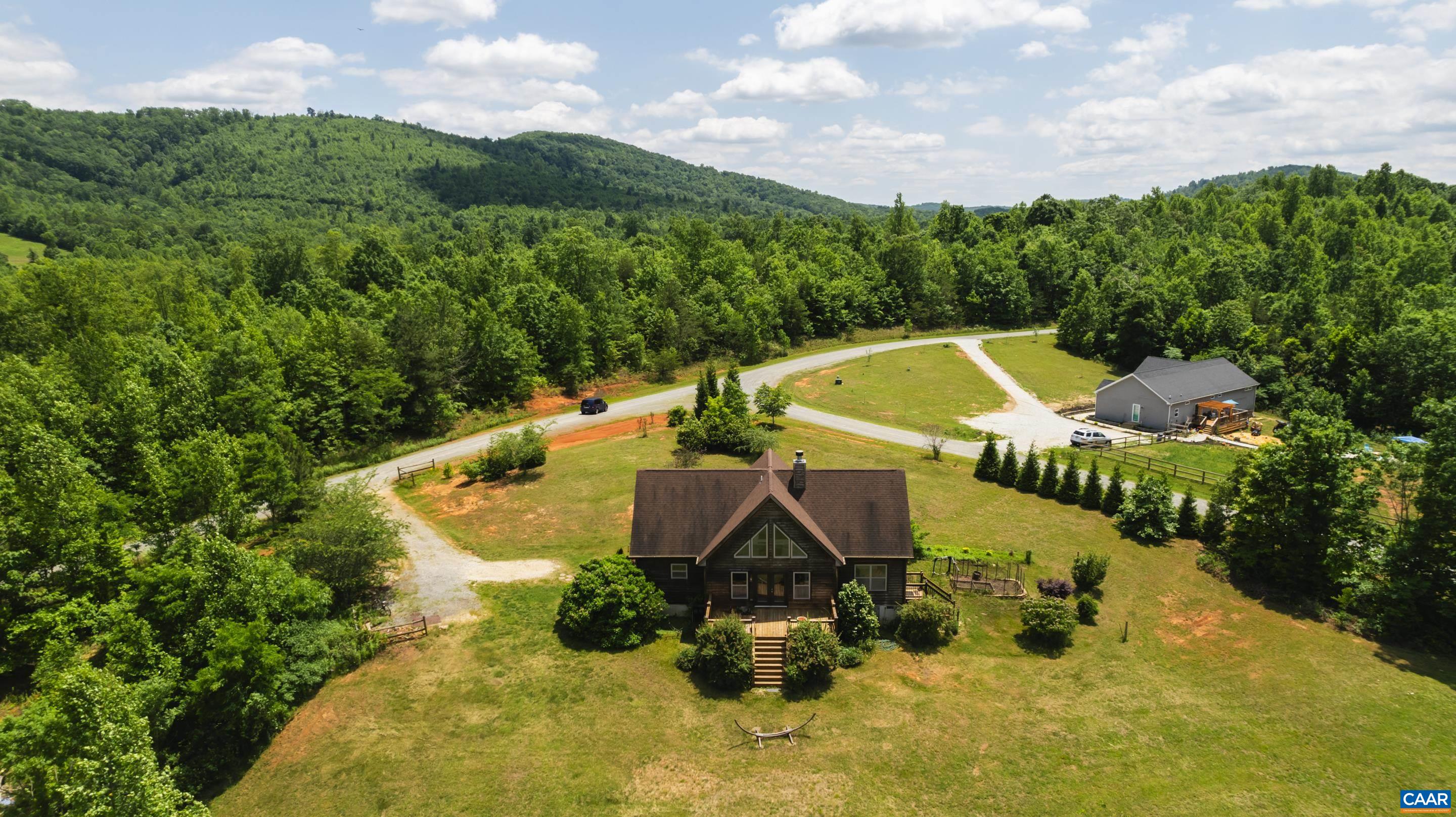 491 Mountain Ridge Lane Shipman, VA 22971 - Photo 3 of 35 an aerial view of a house with swimming pool and mountains