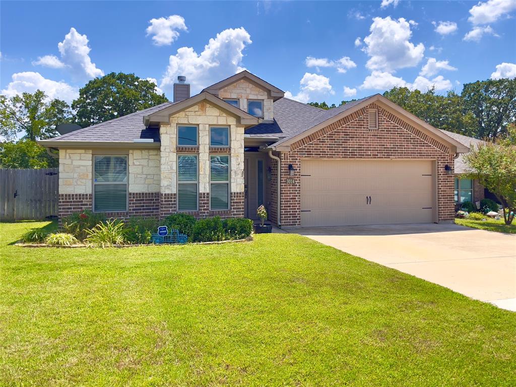 a view of a house with a yard and garage