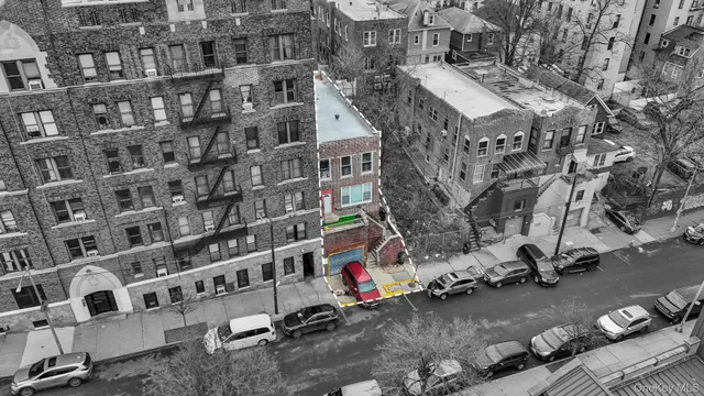 a front view of a building with parked cars