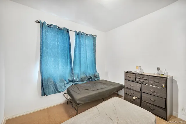 a bedroom with a bed and cabinets