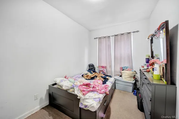 a bedroom with bed and a window