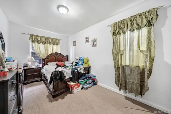 a bedroom with furniture and a window
