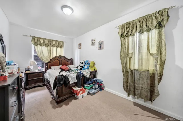 a bedroom with furniture and a window