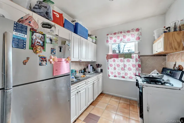 a kitchen with stainless steel appliances a refrigerator and a stove top oven