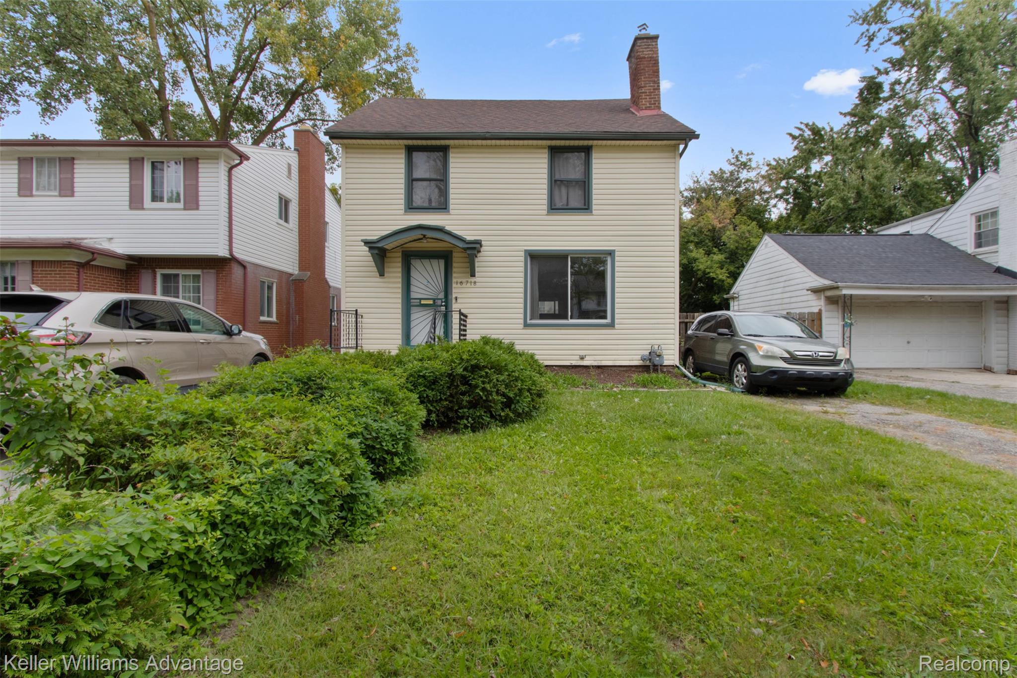 16718 Sunderland Road Detroit, MI 48219 - Photo 2 of 19 View of front of property with a chimney, a front lawn, and a garage