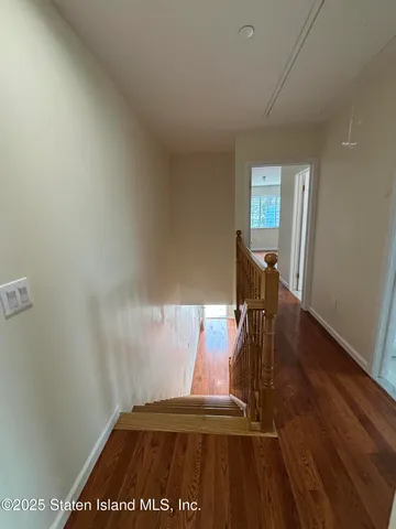 a view of a bedroom with wooden floor