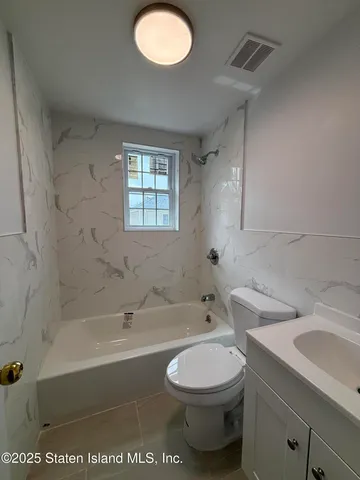 a bathroom with a sink a toilet and bathtub