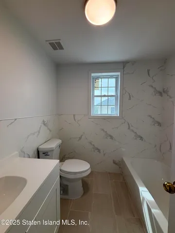 a bathroom with a sink a toilet and bathtub