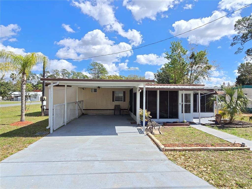 a view of a house with sitting area and yard with furniture