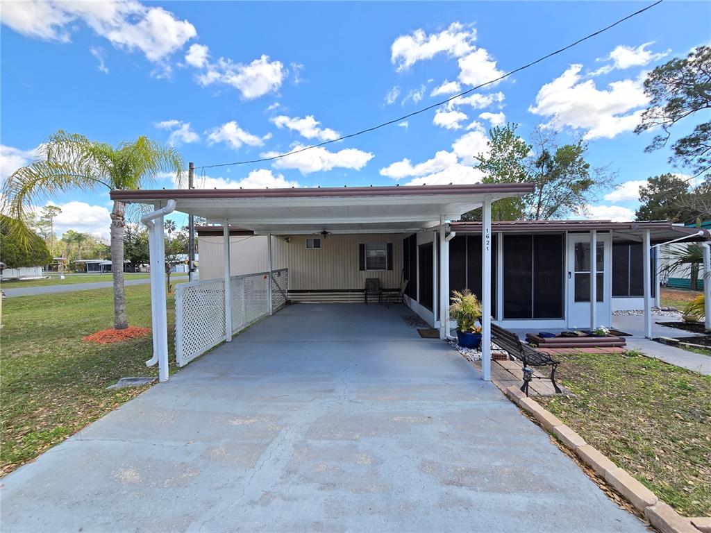 1621 Haddock Street St. Cloud, FL 34771 - Photo 19 of 46 a view of a house with backyard porch and sitting area