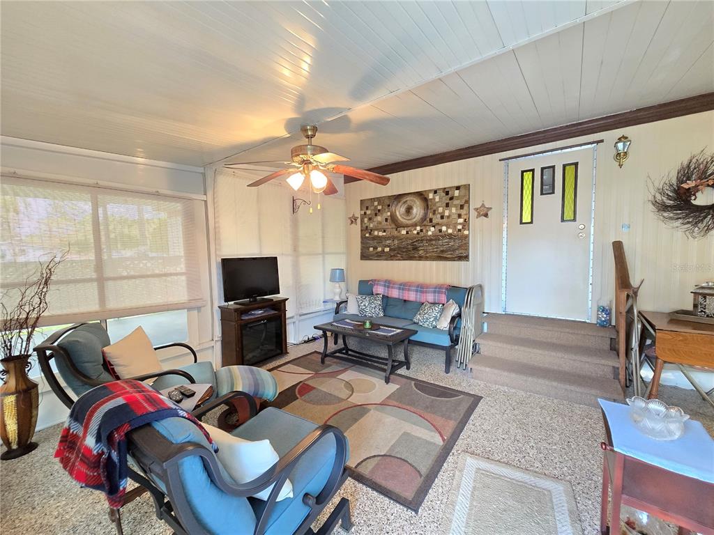 1621 Haddock Street St. Cloud, FL 34771 - Photo 20 of 46 a living room with furniture a flat screen tv and a large window
