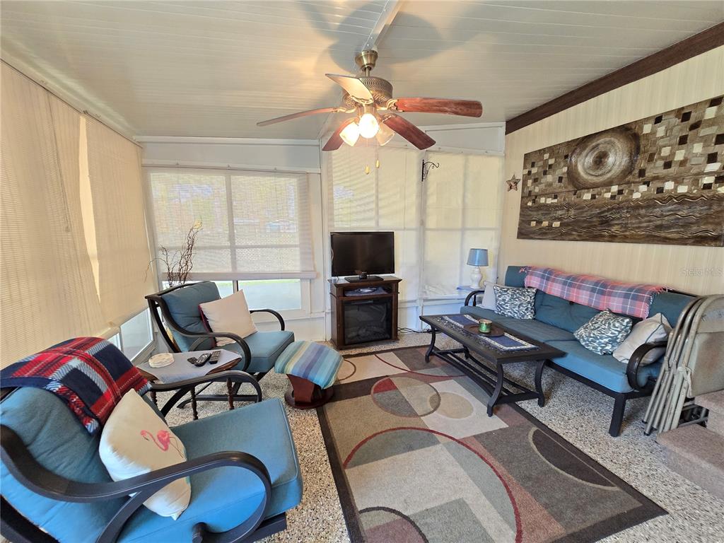 1621 Haddock Street St. Cloud, FL 34771 - Photo 22 of 46 a living room with furniture a flat screen tv and a window