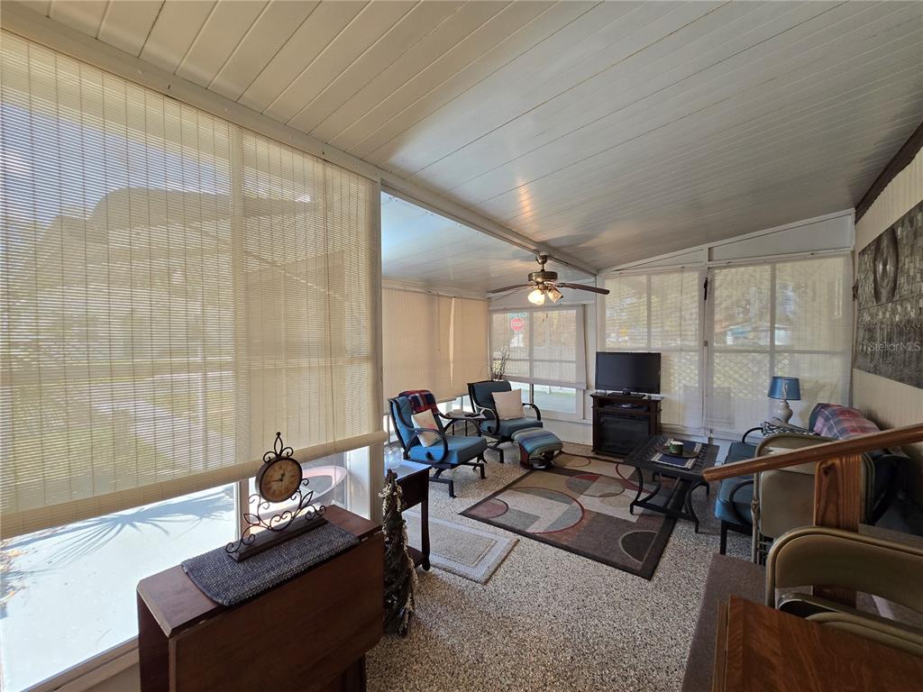 1621 Haddock Street St. Cloud, FL 34771 - Photo 24 of 46 a living room with furniture a flat screen tv and a window