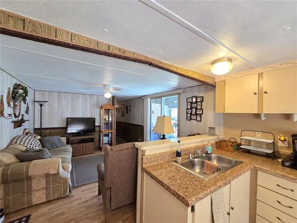 a kitchen with a sink cabinets and window