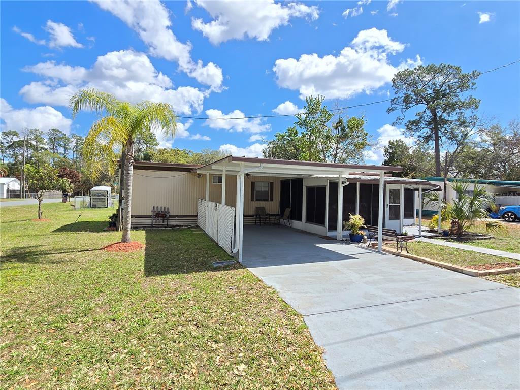 1621 Haddock Street St. Cloud, FL 34771 - Photo 3 of 46 a view of a house with backyard and sitting area