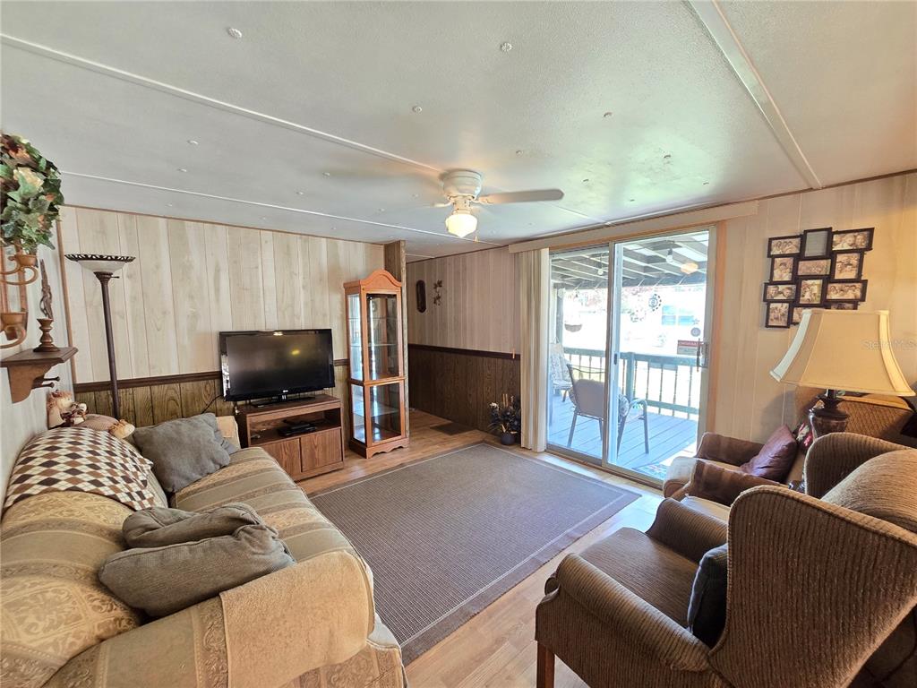 1621 Haddock Street St. Cloud, FL 34771 - Photo 32 of 46 a living room with furniture a flat screen tv and a large window