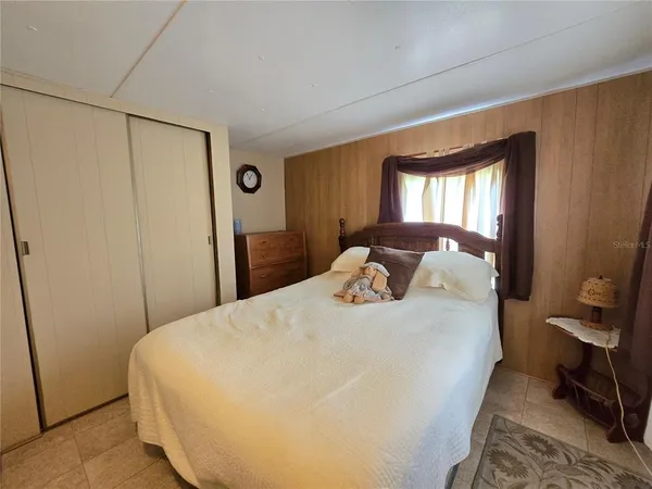 a bedroom with bed and a window