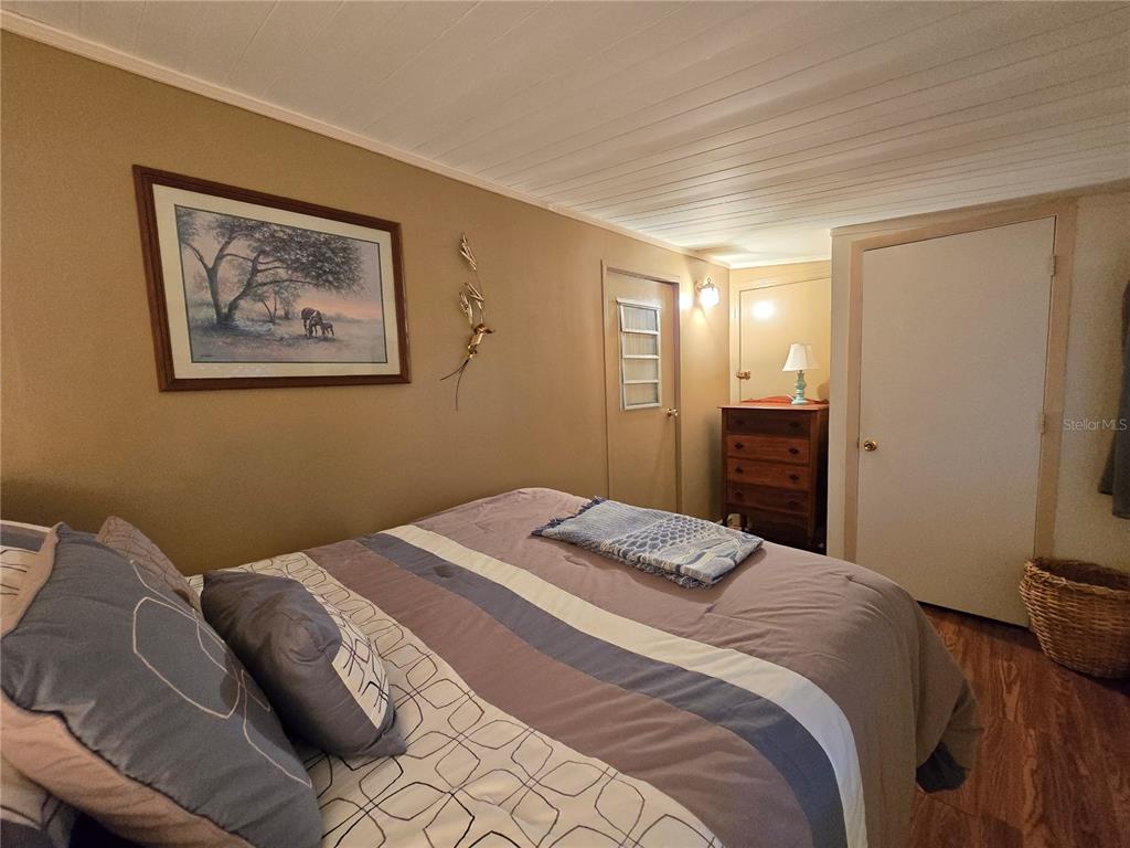 1621 Haddock Street St. Cloud, FL 34771 - Photo 38 of 46 a bedroom with a bed and a painting on the wall