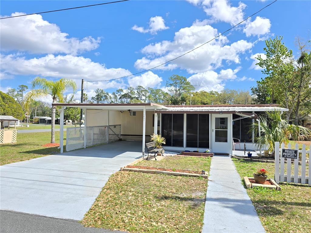 1621 Haddock Street St. Cloud, FL 34771 - Photo 4 of 46 a view of a house with a swimming pool and sitting area