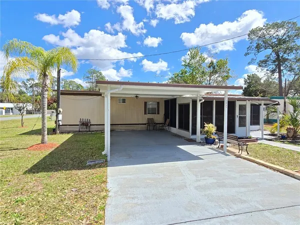 a view of a house with backyard sitting area and garden