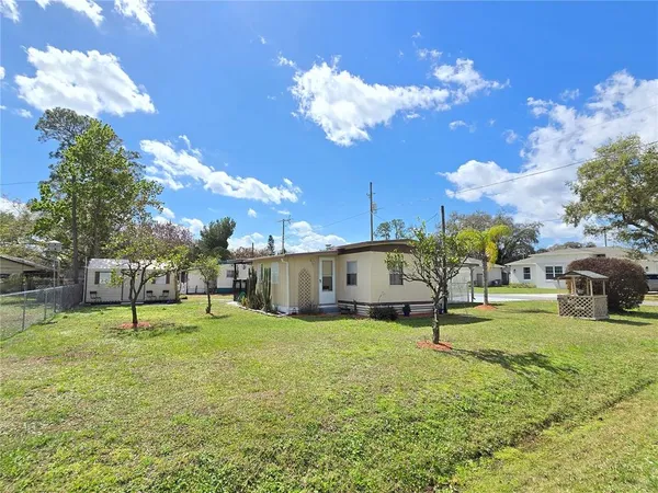 a view of a house with a backyard