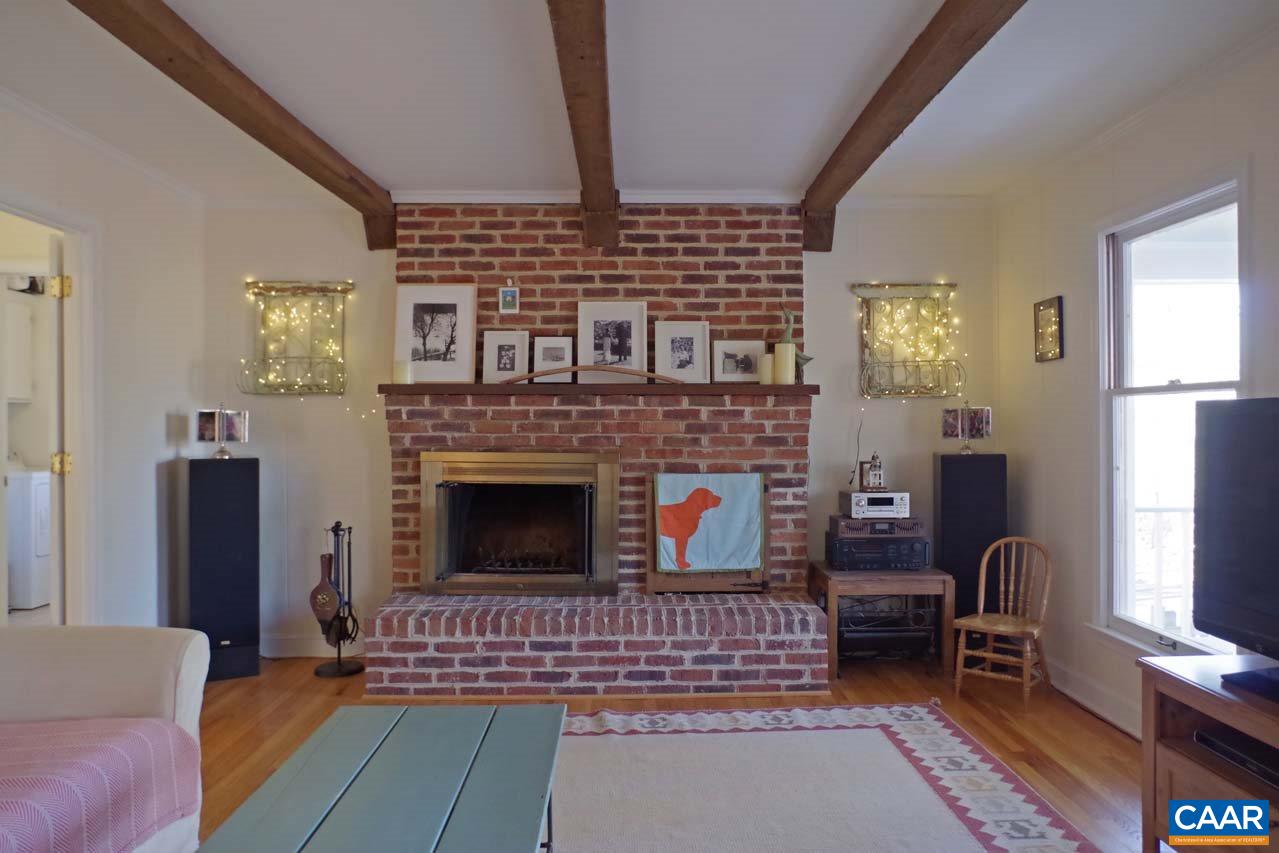 2657 Cardinal Ridge Road Charlottesville, VA 22901 - Photo 11 of 50 a living room with furniture a fireplace and a table