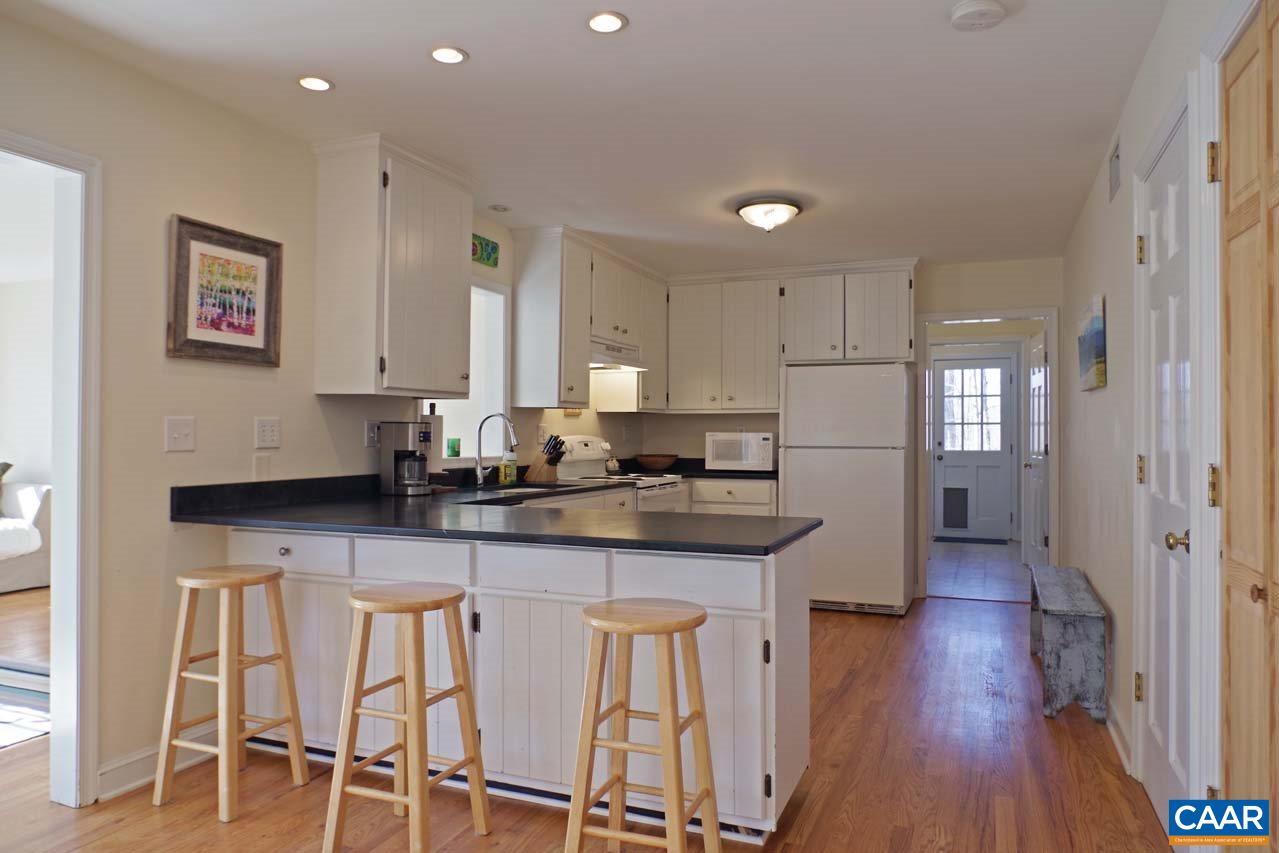 2657 Cardinal Ridge Road Charlottesville, VA 22901 - Photo 13 of 50 a kitchen with granite countertop white cabinets and chairs