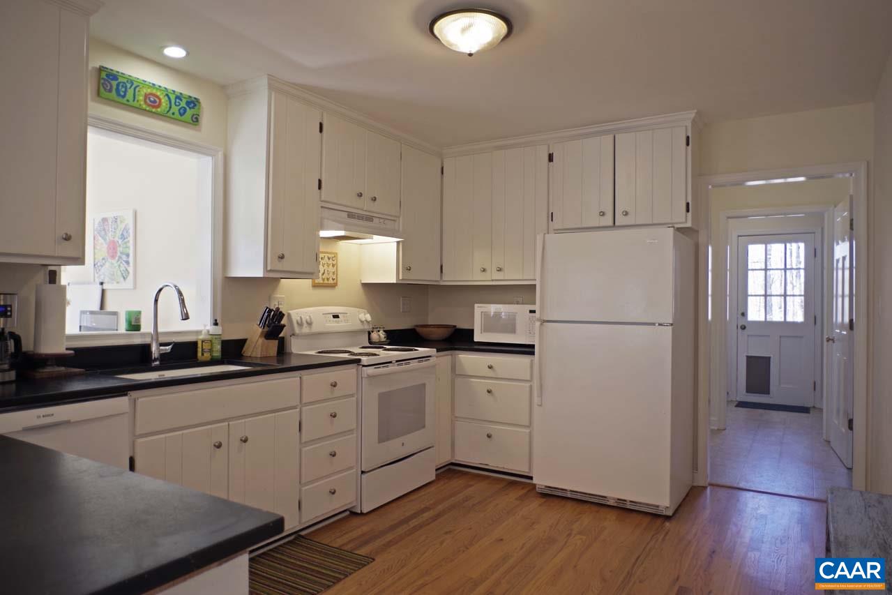 2657 Cardinal Ridge Road Charlottesville, VA 22901 - Photo 15 of 50 a kitchen with a sink a refrigerator a stove and white cabinets