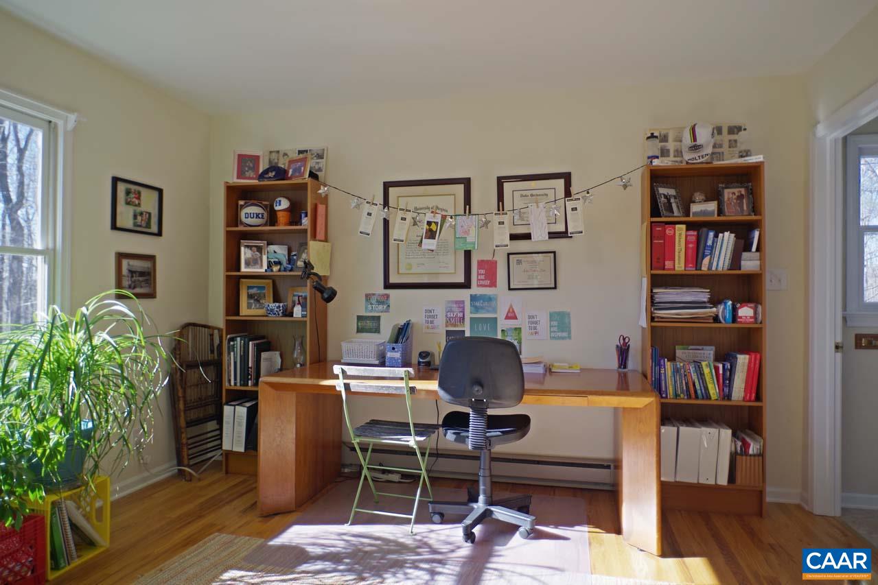2657 Cardinal Ridge Road Charlottesville, VA 22901 - Photo 25 of 50 a view of a workspace with bookshelf and a window