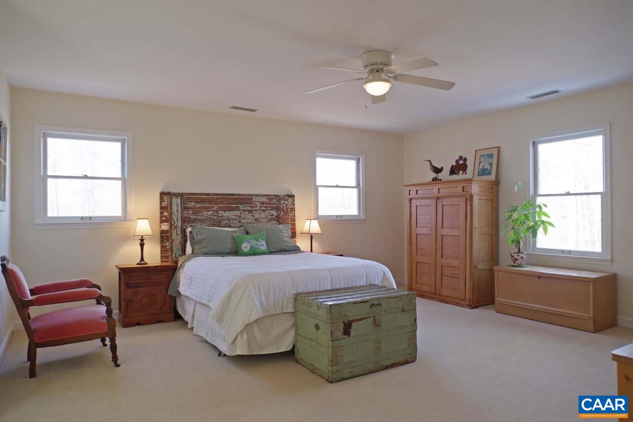 2657 Cardinal Ridge Road Charlottesville, VA 22901 - Photo 30 of 50 a bedroom with a bed and a couch
